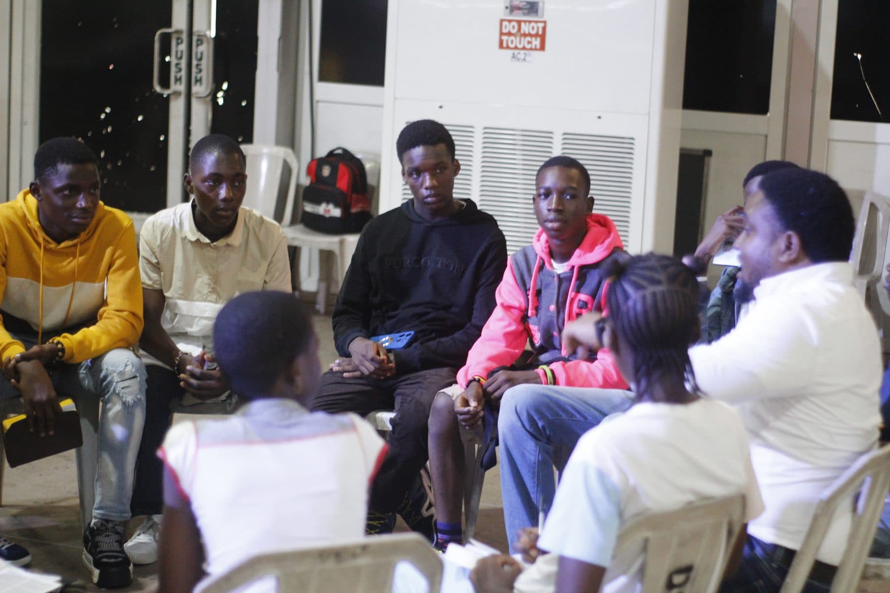 A General talking with teens in a breakout group